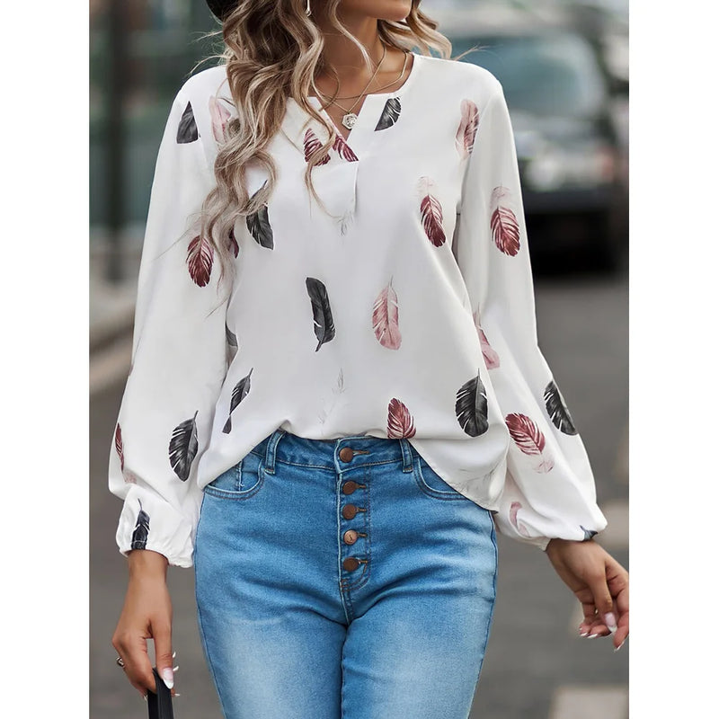 Elegant chiffon blouse with feather pattern—long sleeves and stylish design for a chic look.