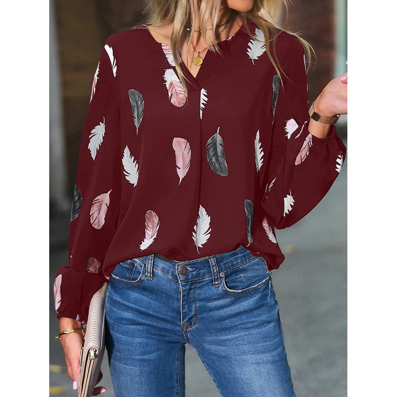 Elegant chiffon blouse with feather pattern—long sleeves and stylish design for a chic look.