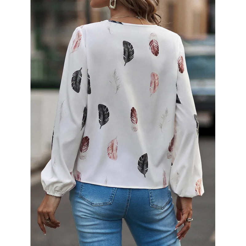 Elegant chiffon blouse with feather pattern—long sleeves and stylish design for a chic look.