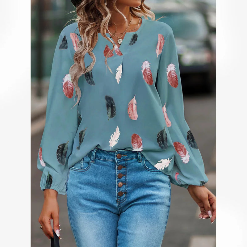 Elegant chiffon blouse with feather pattern—long sleeves and stylish design for a chic look.