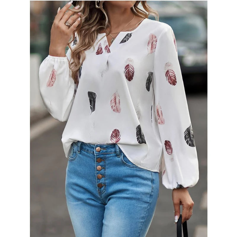 Elegant chiffon blouse with feather pattern—long sleeves and stylish design for a chic look.