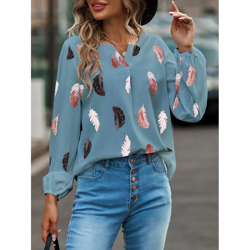 Elegant chiffon blouse with feather pattern—long sleeves and stylish design for a chic look.