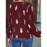 Elegant chiffon blouse with feather pattern—long sleeves and stylish design for a chic look.