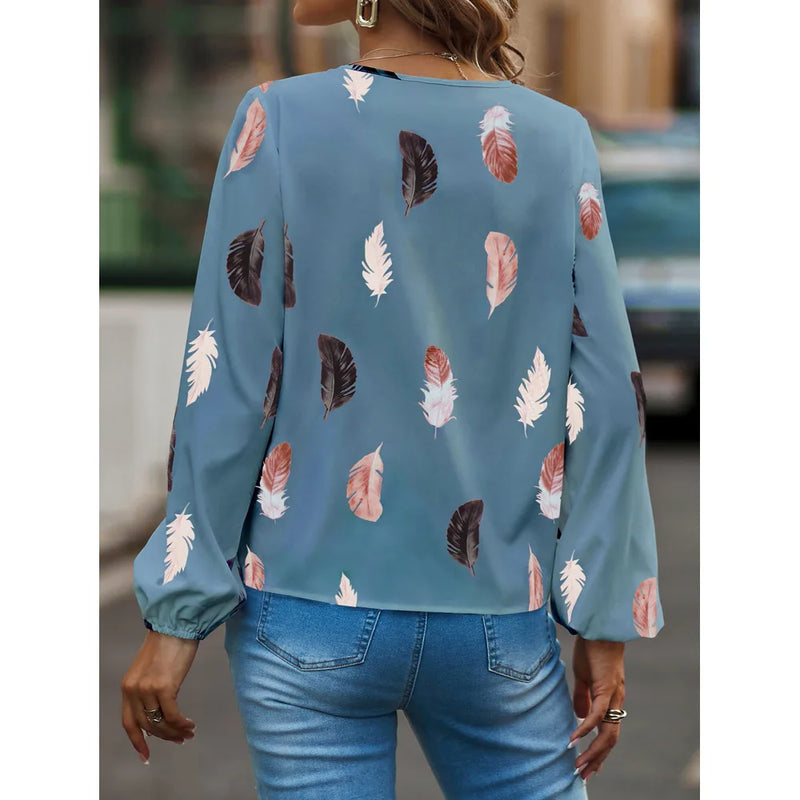 Elegant chiffon blouse with feather pattern—long sleeves and stylish design for a chic look.