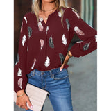 Elegant chiffon blouse with feather pattern—long sleeves and stylish design for a chic look.