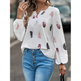 Elegant chiffon blouse with feather pattern—long sleeves and stylish design for a chic look.